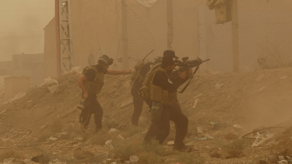 In this May 14, 2015 file photo, security forces defend their headquarters against attacks by Islamic State extremists during a sandstorm in the eastern part of Ramadi, the capital of Anbar province, Iraq.