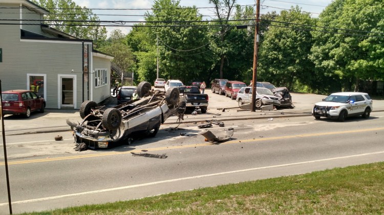 A pickup truck rests on its roof on Main Street in Farmington after leading a Franklin County Sheriff’s deputy on a chase, and crashing into three parked vehicles. The teenaged driver was taken to the hospital and faces charges.