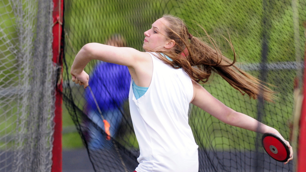 Monmouth’s Maddie Amero heaves the discus during the Capital City Classic at Cony High last Friday.