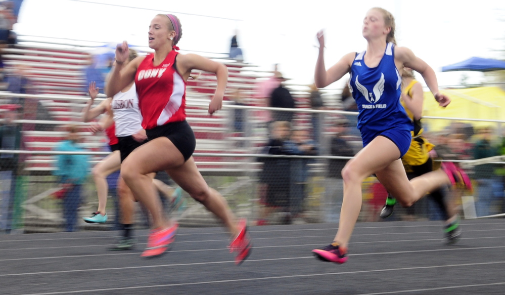Cony’s Madeline Reny, left, leads Erskine Academy’s Jordan Jowett on way to winning the 100 meters during the Capital City Classic last week at Cony High School in Augusta.