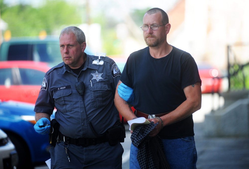 Mark Bussell is escorted Friday from Somerset County Superior Court in Skowhegan by Correctional Officer Charles Haley to a transport vehicle bound for the Somerset County jail, where he will await transfer to state prison to serve his sentence for a manslaughter conviction.