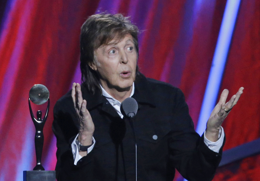 In this file photo dated Sunday April 19, 2015, Paul McCartney introduces Ringo Starr at the Rock and Roll Hall of Fame induction ceremonies,  in Cleveland, USA.
