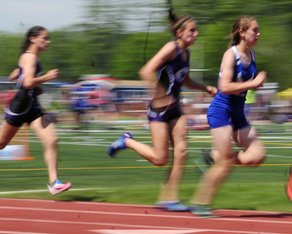 Erskine Academy’s Kaylee Porter, left, runs the 800 meters during the KVAC track meet Saturday in Bath.