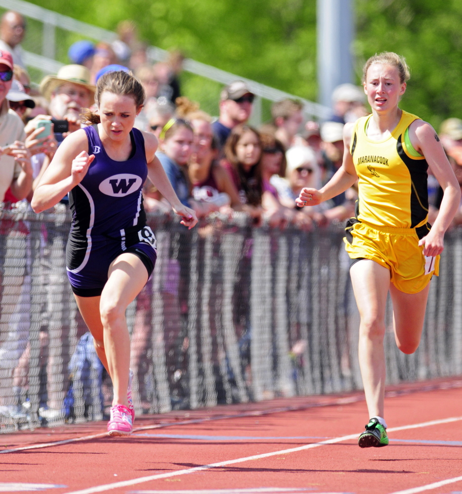Waterville’s Amy Samson, left, and Maranacook’s Lindsay Perkins run the 200 meter dash Saturday during the KVAC track meet in Bath.