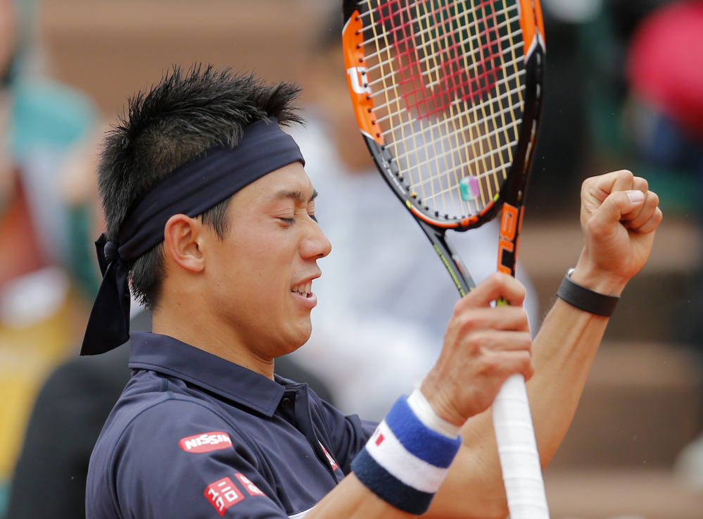 Japan’s Kei Nishikori reacts after defeating Russia’s Teymuraz Gabashvili during their fourth round match of the French Open tennis tournament at the Roland Garros stadium, Sunday in Paris.