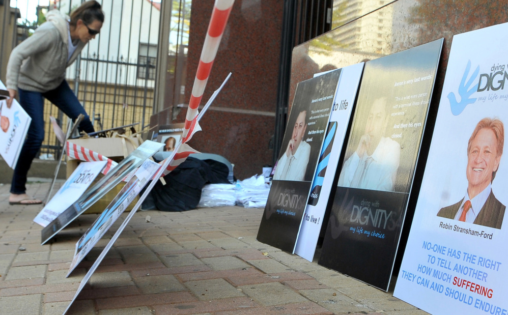 Placards are placed outside the high court in Pretoria, South Africa, where a euthanasia case was being heard.