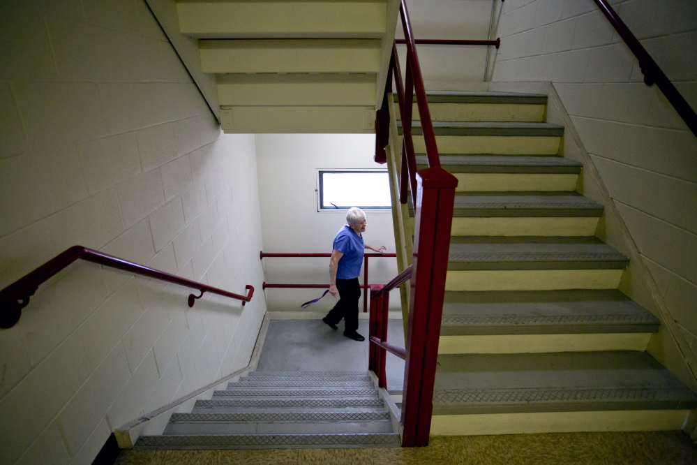 Jane Croston makes her way down the stairs at 425 Broadway in South Portland. She has friends who are selling their houses but can’t find affordable apartments. “The need is so huge and the resources are so inadequate,” she said.