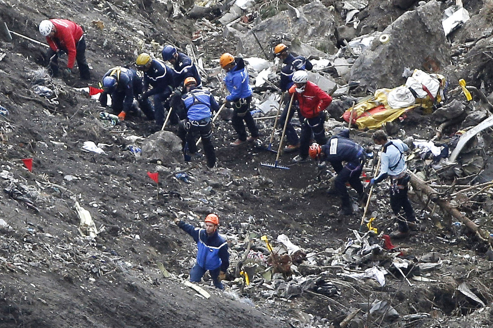 In this March 26, 2015 file photo, rescue workers work on debris of the Germanwings jet at the crash site near Seyne-les-Alpes, France.