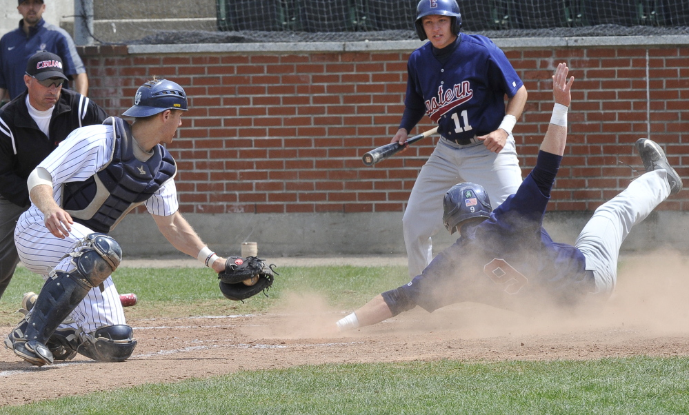 Eastern Connecticut’s Kyle Hart scores a run as Southern Maine catcher Dylan Morris gets a late throw in the first game Saturday in Gorham.  Eastern Connecticut won the first game to force an all-or-nothing matchup for the Little East title. And that’s the one USM won.