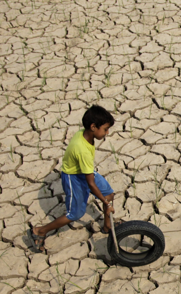 A boy plays on a parched rice paddy field in Ranbir Singh Pura, India, last year, when a delay in the monsoon season began raising fears that an El Nino drought was imminent.