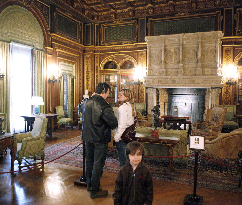 Visitors view the library of The Breakers, a 70-room Vanderbilt family summer estate in Newport, R.I. The Newport Preservation Society’s chairman says objects donated by Vanderbilt family members who criticize the management of the mansion are not “highly significant.”