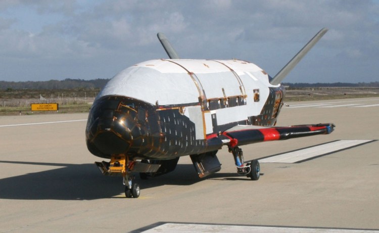 The unmanned X-37B looks like a miniature NASA space shuttle and launches vertically and lands horizontally. But no one flies aboard the spacecraft.