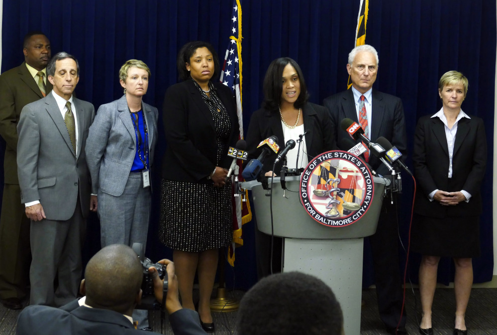 Baltimore States Attorney Marilyn Mosby, center, announces the indictments of six Baltimore police officers Thursday on various charges related to the arrest and death of Freddie Gray.