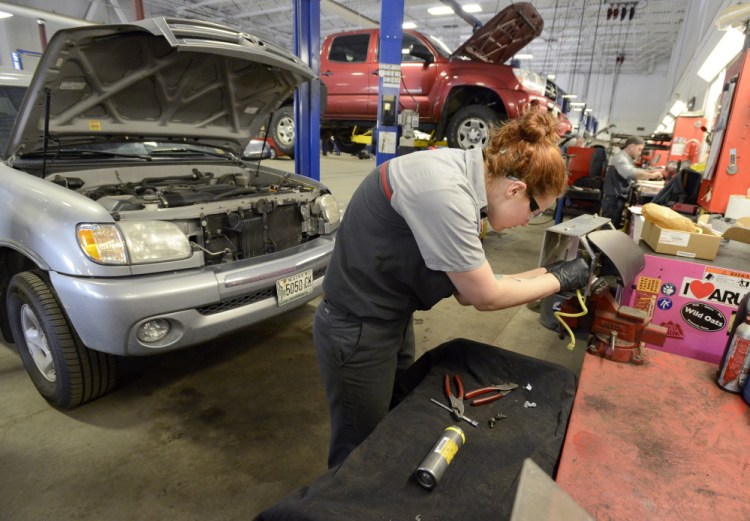 Auto technician Becky McInnis changes the inflator module on a 2003 Toyota Tundra at Lee Toyota in Topsham on Thursday. Japanese auto supplier Takata has issued recalls on 34 million airbags, but so far “customers are slightly less concerned than you may think,” said Adam Lee, owner of Lee Auto Malls.