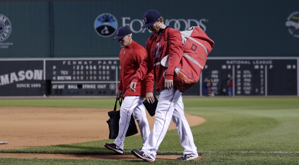 Mike Brenly, foreground, walking to the Fenway Park dugout with bullpen coach Dana LeVangie, reached the crossroads most minor leaguers reach – whether to keep playing or move on. When the Red Sox offered Brenly the chance to become a bullpen catcher, he took it.