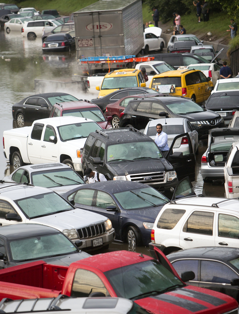 Motorists are  stranded along I-45 along North Main  in Houston after storms flooded the area, Tuesday.