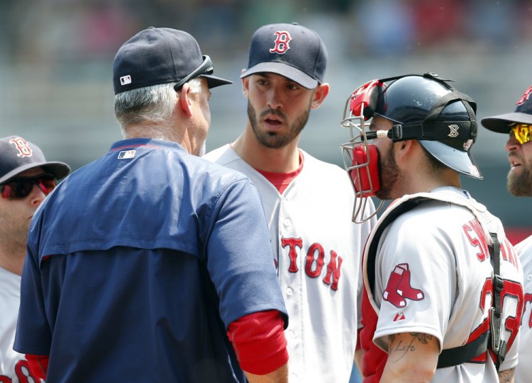 Red Sox pitching coach Carl Willis, left, talks with pitcher Rick Porcello after Porcello gave up an RBI single to the Twins’ Joe Mauer in the third inning of Wednesday’s game in Minneapolis. Porcello allowed six earned runs in seven innings.