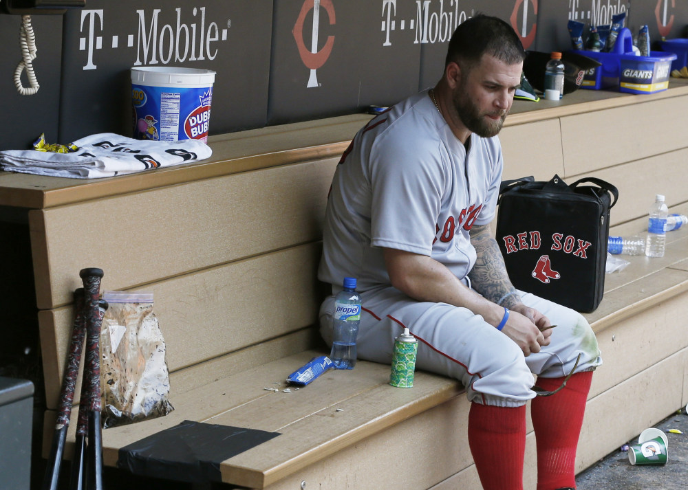 Boston’s Mike Napoli sits alone in the dugout after Wednesday’s 6-4 loss to the Minnesota Twins. The Twins swept the three-game series.