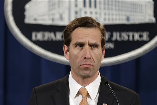 In this Feb. 5, 2013 file photo, Delaware Attorney General Beau Biden pauses while speaking at a news conference at the Justice Department in Washington. On Saturday, May 30, 2015, Vice President Joe Biden announced the death of his son, Beau, from brain cancer. (AP Photo/Jacquelyn Martin)