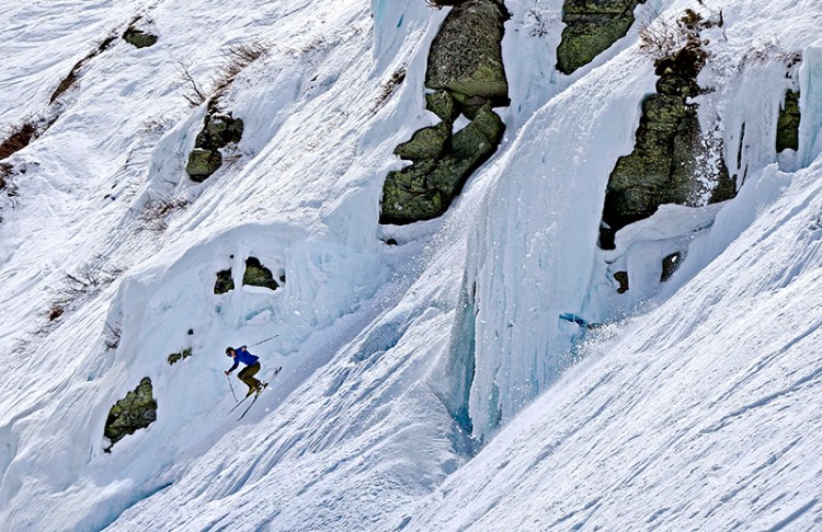 Silas Miller, 28, of Conway, N.H. sails more than 50 feet off an ice-covered cliff on the Headwall of Tuckerman Ravine on Mount Washington in May.