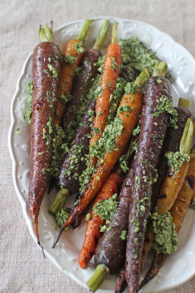 Grilled carrots with carrot top pesto. The Associated Press