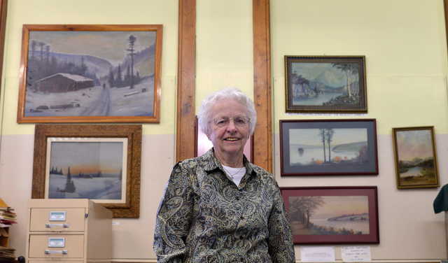 Lena Arno, with the Madison Historical and Genealogical Society, stands with art works created by local artist Willis Pelton on Friday,  May 8, 2015. The exhibit runs from 1pm to 4pm on Saturday and is free to the public.