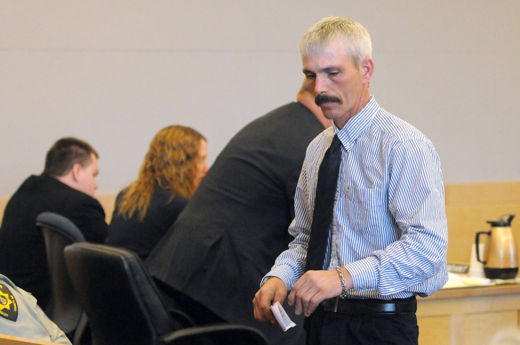 Kyle Dube's father, Greg Dube, walks back to his seat after making a statement about his son Friday at the Penobscot Judicial Center in Bangor. Kyle Dube, who used a phony Facebook profile to lure a teenage girl to her death, was sentenced to 60 years in prison.