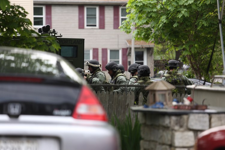 Portland police reaction team on scene in East Deering. Heavily armed police congregated at the rear of a house on Washington Avenue. Whitney Hayward / Staff Photographer