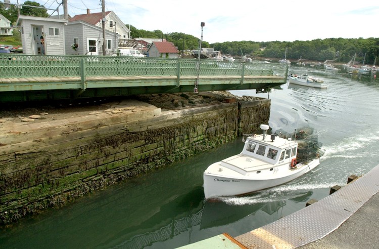A lobster boat passes through the Gut Passage in South Bristol, one of Maine's last remaining swing bridges. Cianbro has a contract to replace the bridge and needs skilled workers for that job and many other projects in Maine and along the Eastern Seaboard. Press Herald file photo