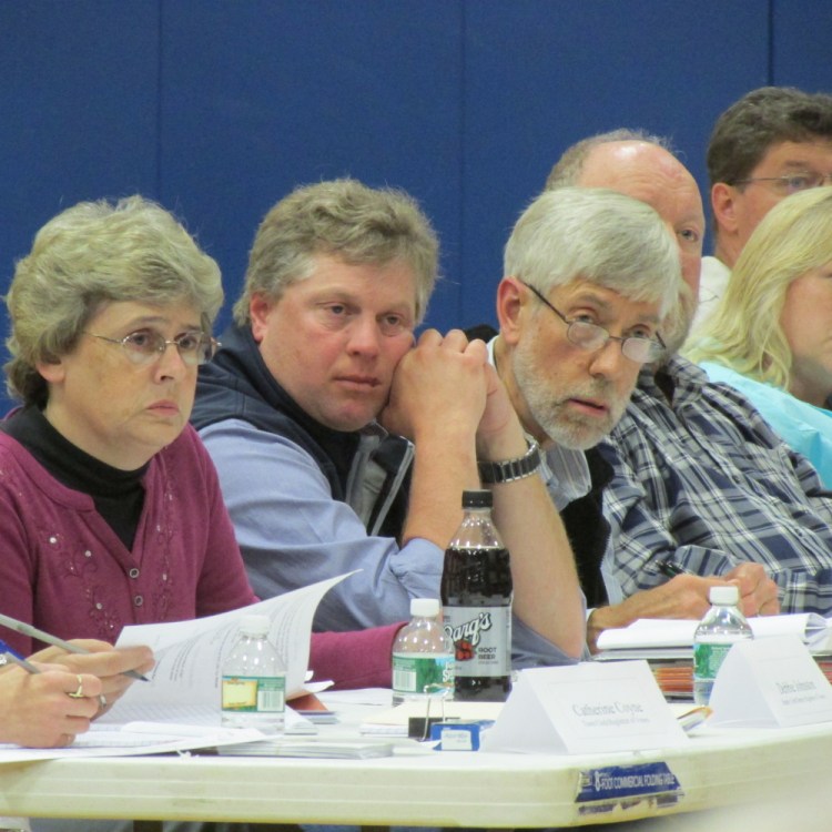 Vassalboro Town Manager Mary Sabins and Selectmen Robert Browne and Philip Haines listen to a resident’s question at annual town meeting held Monday evening at the Vassalboro Community School.
