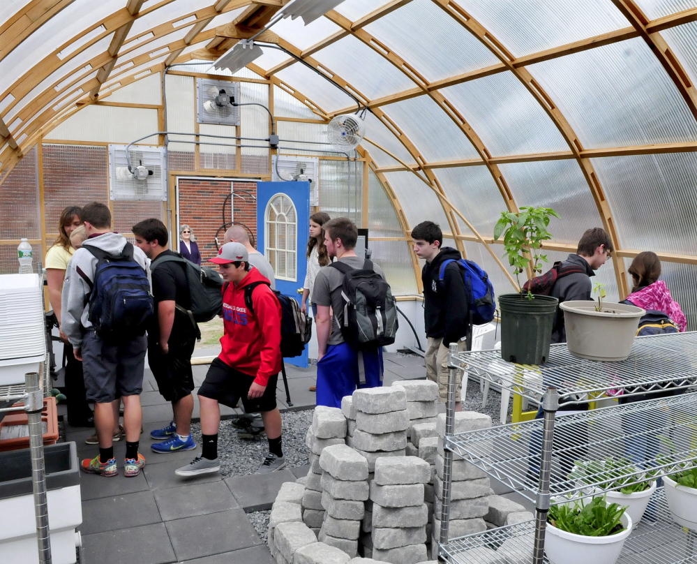 Messalonskee students enter and tour the new greenhouse during an official opening Wednesday at the Oakland school. Students, staff members, area businesses and organizations and grant money helped build the greenhouse.