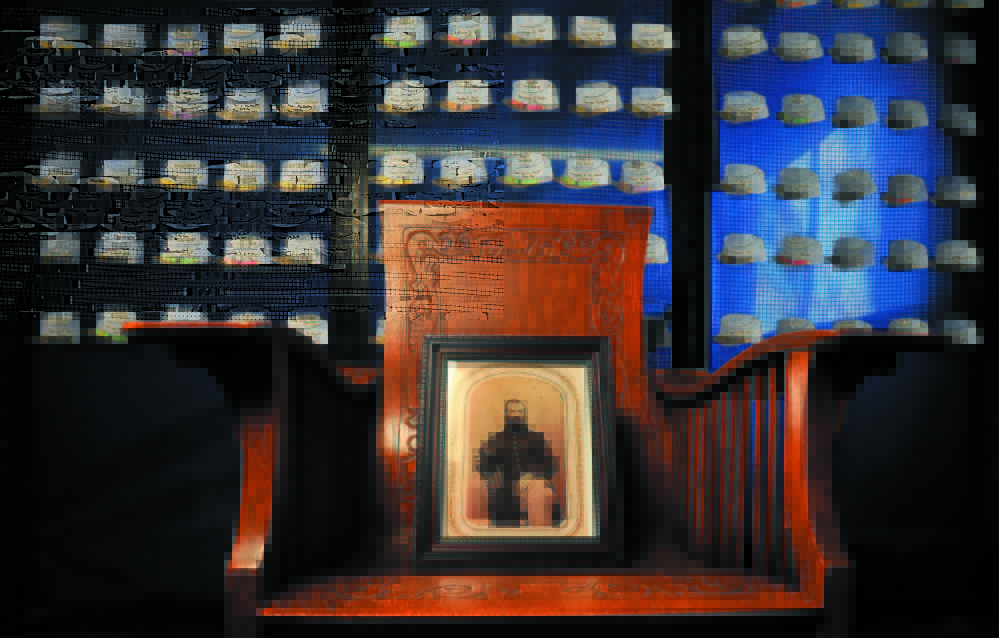 A picture of Capt. Charles W. Billings sits on a chair in front Union hats representing each of the 250 Clinton men who served in the Civil War at the Clinton Public Library in 2011. Brown Memorial Library in Clinton will host a Civil War encampment re-enactment as well as rededicate Billings’ monument in town this weekend, to commenorate the 150th anniversariy of the end of the war.