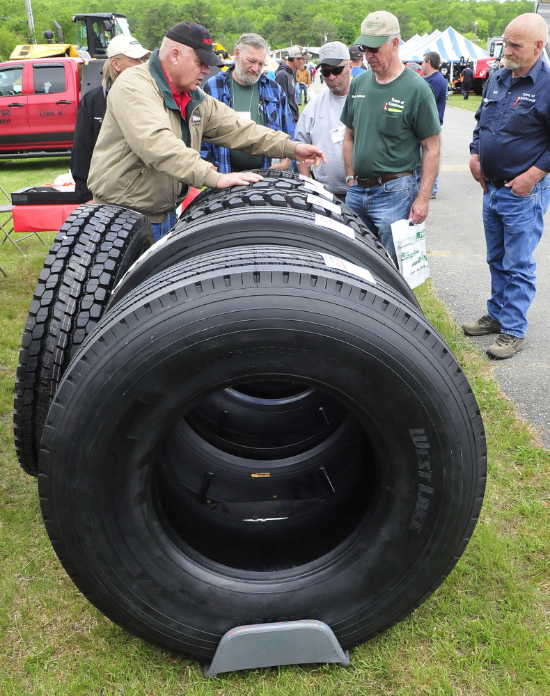 Participants in the American Public Works Highway Congress check out tires for sale Thursday at the Skowhegan Fairgrounds.
