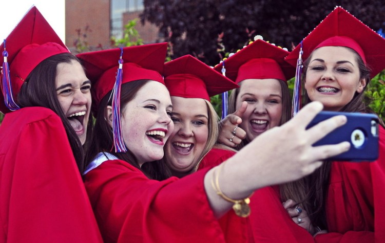 From left, graduates Marisa Schaller, Emma Walsh, Jamie Thomas, Jessie Thomas and Kalea Proctor take a selfie Thursday before the Messalonskee High School graduation at the Augusta Civic Center.