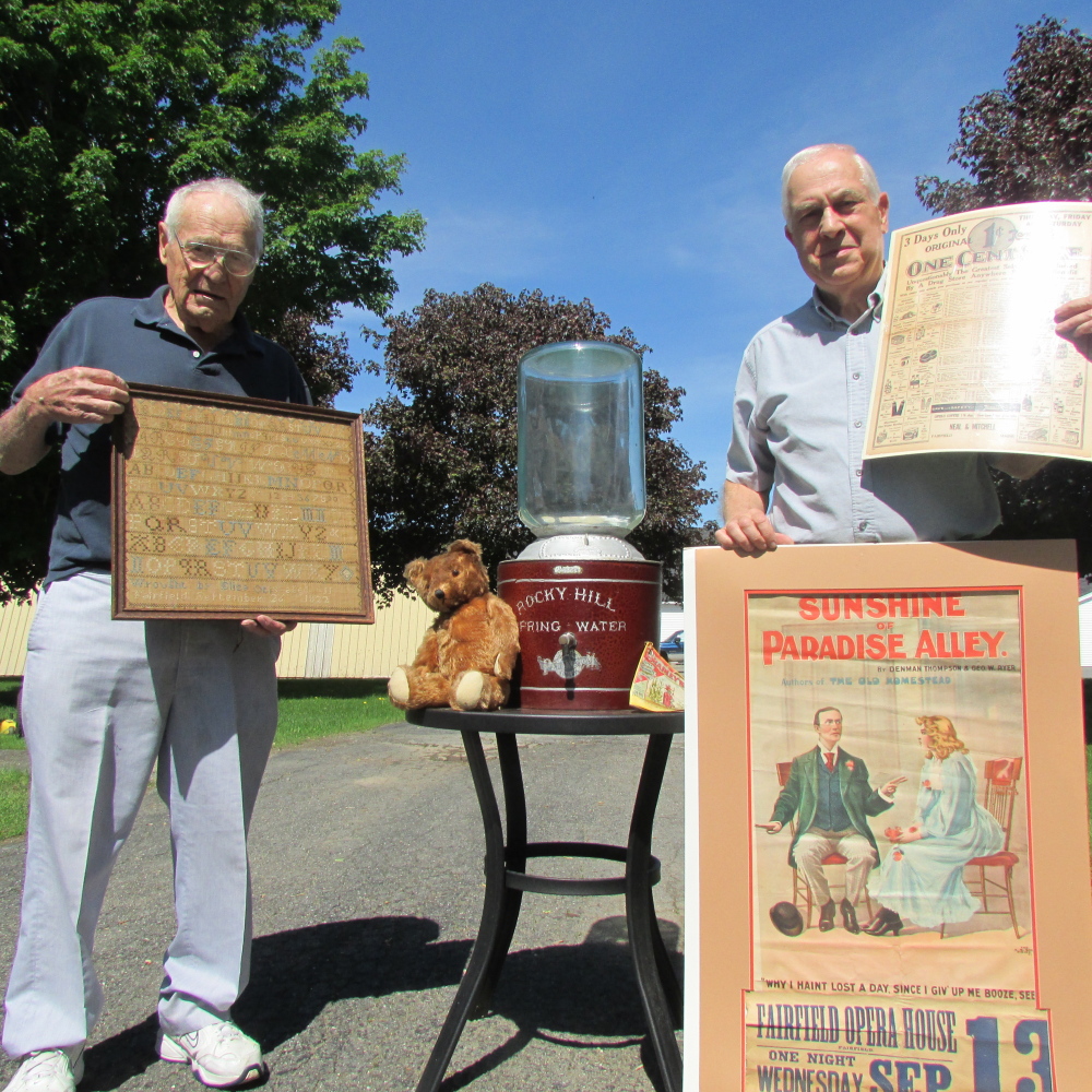 Local antique collector Arthur Julia, left, and Fairfield Historical Society President Doug Cutchin are seen with items that Julia donated to the society recently for its collection of items from Fairfield.
