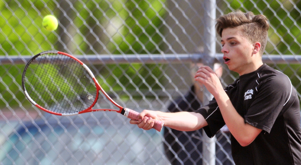 Staff photo by Joe Phelan
Hall-Dale’s Thomas Plourde returns a shot during a doubles match against St. Dominic’s Matt Boulet and Cam Jalbert in a Western C semifinal Friday at Hall-Dale. The Saints won the match 1-6, 7-5, 6-2.