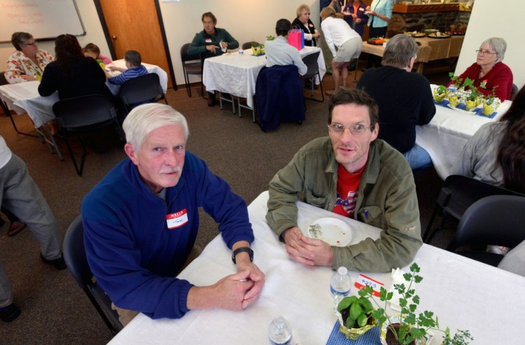 Tom McGuire, left, sits with his student, Ezra Randall Jr., during the annual meeting of Literacy Volunteers Waterville in the Colby Room at Waterville Public Library on Tuesday.