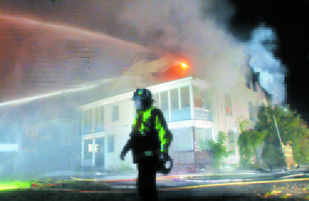Waterville Fire Chief Dave LaFountain stands in front of a three-story apartment building as it burns on Water Street in Waterville in 2011. A proposal is being considered to put together a fire training center for Waterville, Winslow and Fairfield departments. LaFountain says the need for the center is critical.