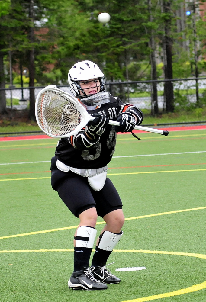Winslow lacrosse goalie Harley Fitch catches a ball during practice Monday in Waterville.