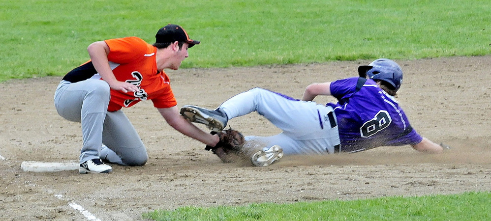 Gardiner’s Brady Smith tags out Waterville’s Cody Pellerin at third base during an Eastern B prelim Tuesday in Waterville. The Panthers won 3-2.