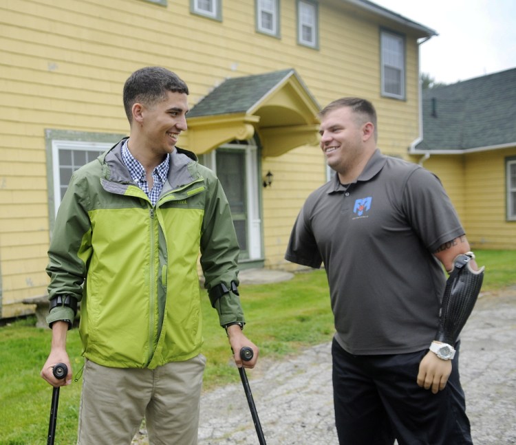 Travis Mills, right, greets John Bobrowiecki at the Travis Mills Foundation National Family Retreat Center in Rome. A kickoff for the renovation and restoration of the retreat for combat-wounded and disabled veterans and their families was held, with several injured veterans in attendance.
