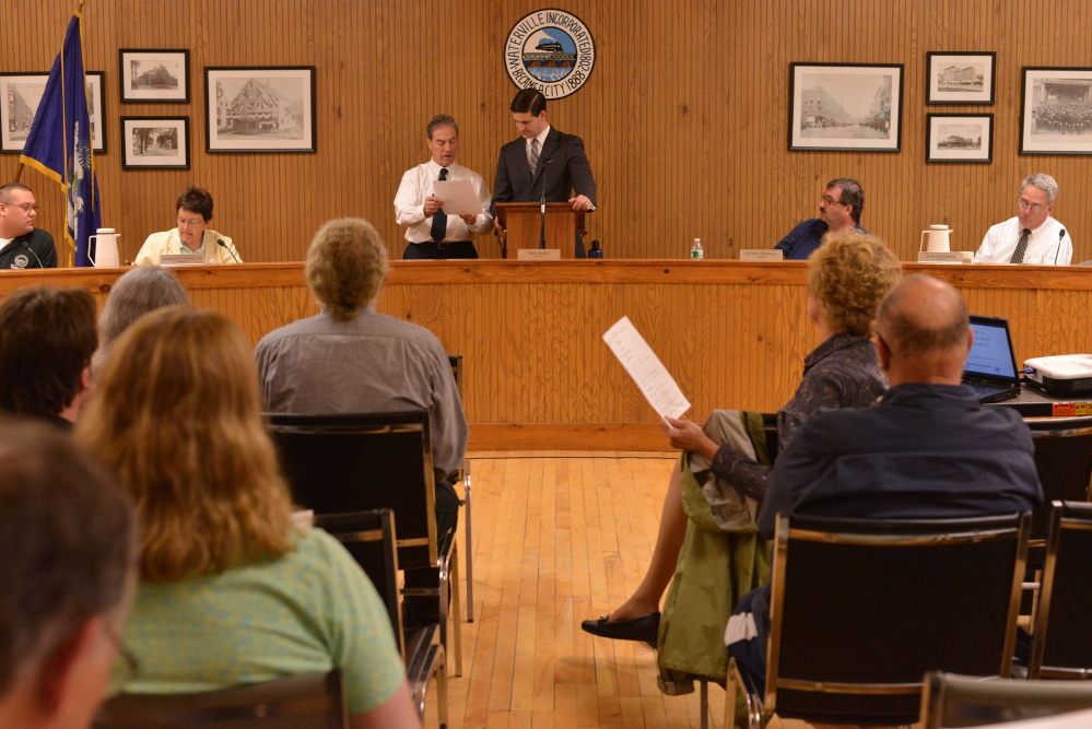 City Manager Mike Roy, left center, and Mayor Nick Isgro discuss the meeting agenda Tuesday in the City Council chambers during a meeting about Waterville’s city budget.