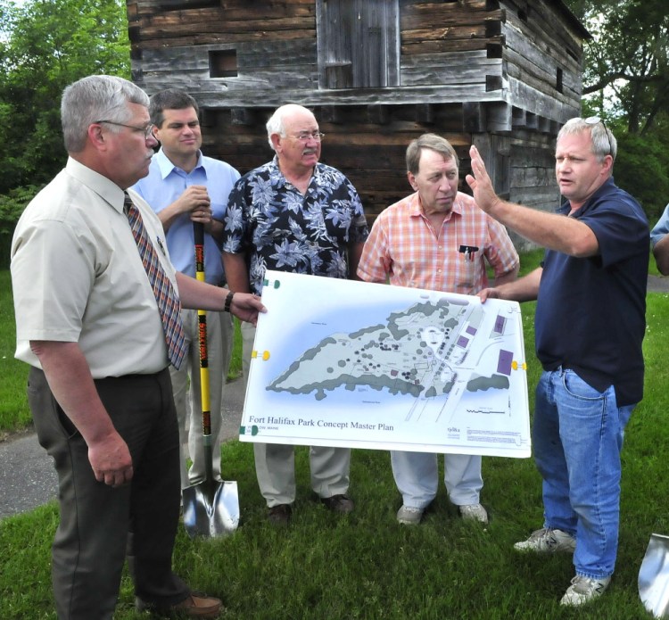 Winslow officials and committee members, shown Wednesday, discuss the Fort Halifax improvement project that will begin this summer in Winslow. The $200,000 project will include relocation of the parking lot area and trails to enhance the historic fort site, background. From left are Town Manager Mike Heavener, Jim Bourgoin, Ken Fletcher, Gerald Saint Amand and Ray Caron.