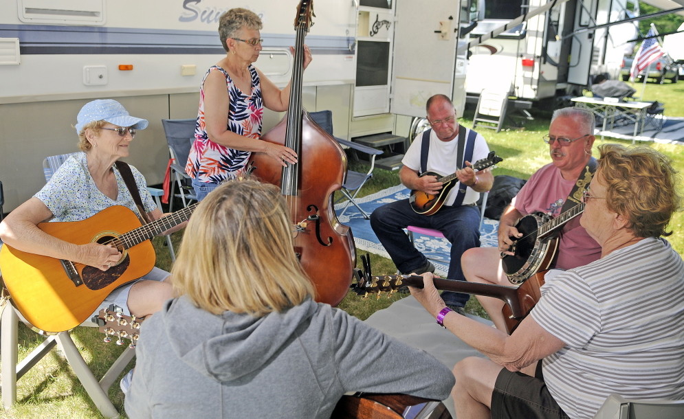 LITCHFIELD, ME - JUNE 19: Guests at the Blistered Fingers Family Bluegrass Music Festival pick together Thursday June 19, 2014 at the Litchfield Fairgrounds.  Bluegrass acts start Wednesday on the main stage and performances continue through Saturday.(Photo by Andy Molloy/Staff Photographer)