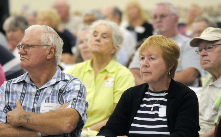 Guests at Scam Jam listen to speakers discuss common scams and fraud targeting the elderly on Thursday at an AARP conference in the Augusta Civic Center.