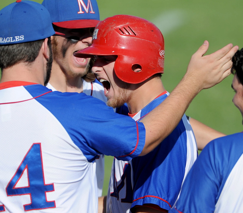 Staff photo by Michael G. Seamans 
 Messalonskee's Zach Mathieu, right center, celebrates with teammates after his solo home run against Oxford Hills during an Eastern A quarterfinal game Thursday in Oakland.