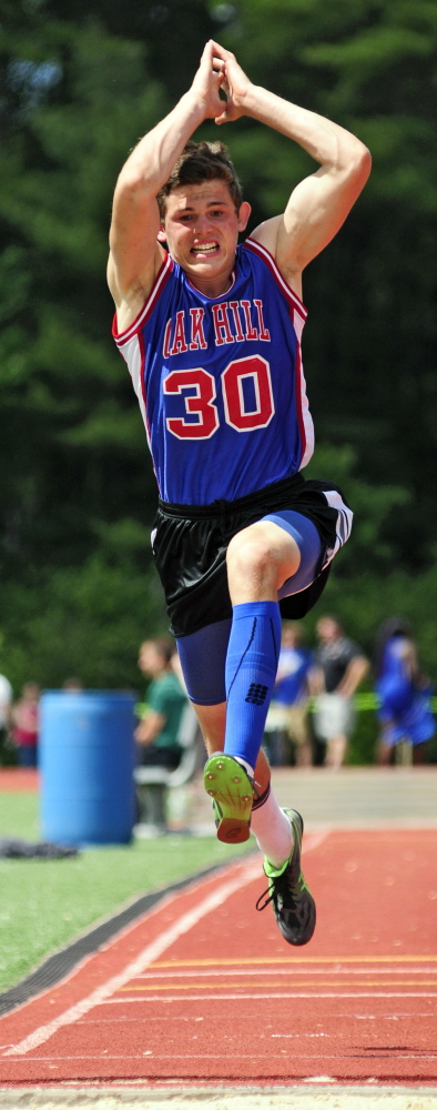 Staff photo by Joe Phelan 
 Oak Hill's Drew Gamage competes in the triple jump during the Class C state track and field championships Saturdayat Yarmouth High School. Gamage will next compete at the New England championships Saturday at Thornton Academy. He's seeded second in the triple jump.