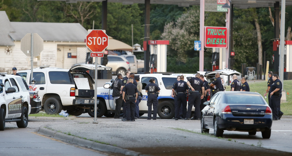 Police block the intersection of Dowdy Ferry Rd and Interstate 45 during a standoff with a gunman barricaded inside a van on Saturday in Hutchins, Texas. The gunman allegedly attacked Dallas Police headquarters.