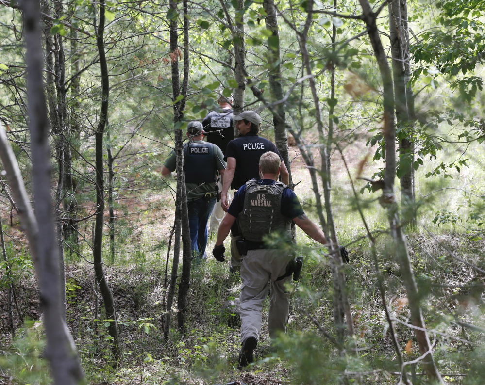 Law enforcement officers search for the ninth day for escaped prisoners David Sweat and Richard Matt on Sunday in Cadyville, N.Y.