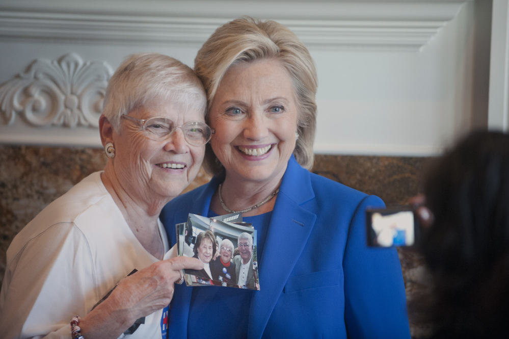 Anita Wendt, of Sioux City, Iowa poses for a photo with Democratic presidential hopeful, former Secretary of State Hillary Rodham Clinton, during a campaign house party Saturday in Sioux City, Iowa.